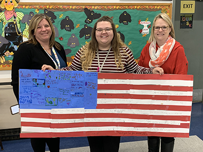 teachers holding american flag